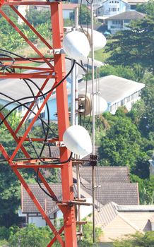 Telecommunication tower closeup with red and white color.