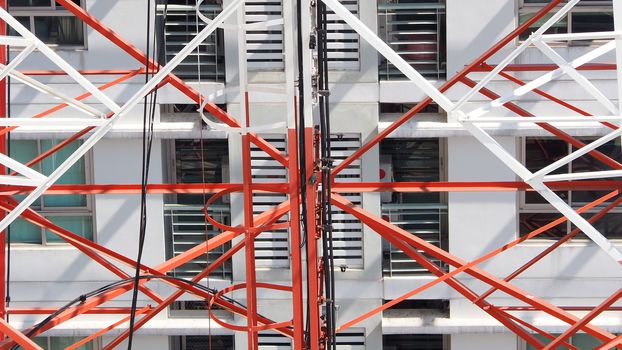 Telecommunication tower closeup with red and white color.