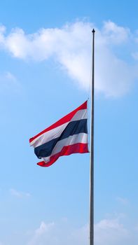 Thailand flag and clear blue sky and white clouds.