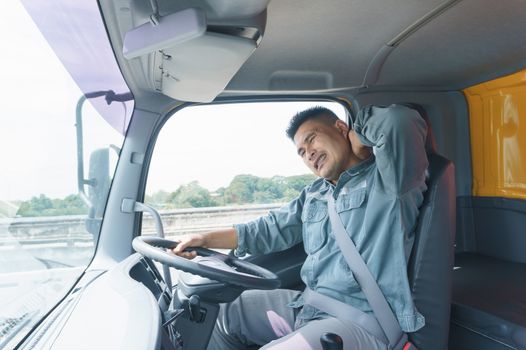 Professional truck driver, adult male, safety belt Yawning and sleepy. Young man worker is confident in the safety of the transport and delivery business for a long time.