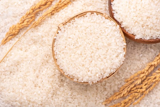 Raw rice in a bowl and full frame in the white background table, top view overhead shot, close up