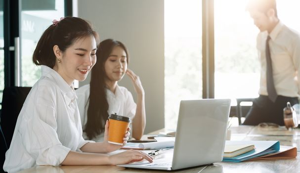 Young asian business people working with documents together at modern office.