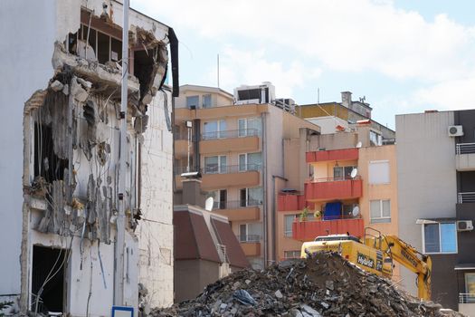 Varna, Bulgaria - August, 04,2020: excavator demolishes a house in a residential area