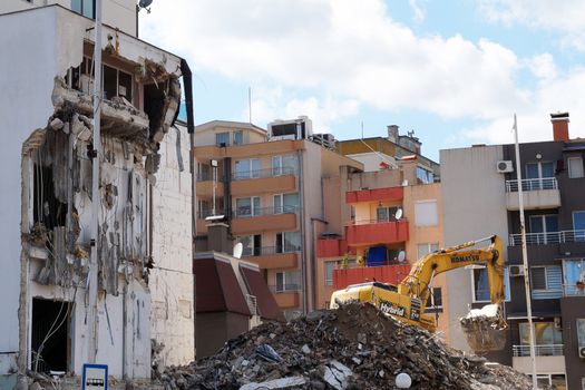 Varna, Bulgaria - August, 04,2020: excavator demolishes a house in a residential area