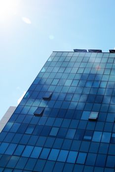 Clouds reflected in the glass facade of a skyscraper.