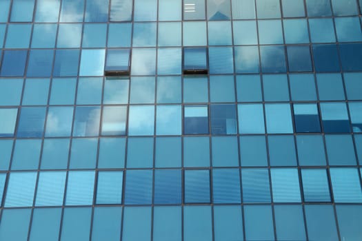 Clouds reflected in the glass facade of a skyscraper.