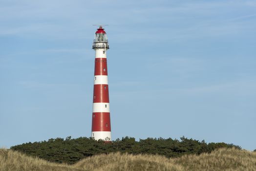 The red and white striped lighthouse of the Wadden island of Ameland in the north of the Netherlands