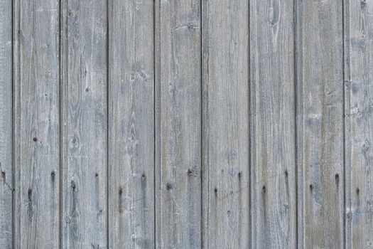 Background photo of weathered old gray wooden scrap with rusted nails shown full screen