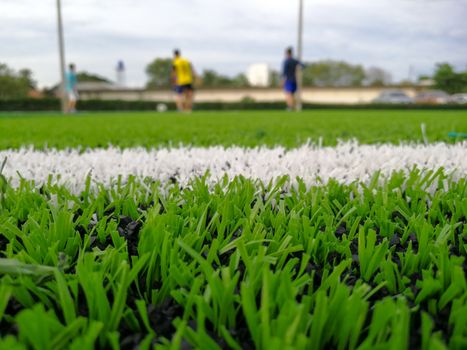 Football field, astro turf surface. Close up of throw in, kick off and corner area. Lushed green football pitch.