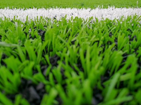 Football field, astro turf surface. Close up of throw in, kick off and corner area. Lushed green football pitch.