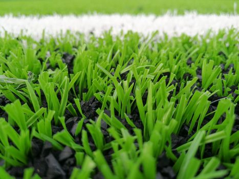 Football field, astro turf surface. Close up of throw in, kick off and corner area. Lushed green football pitch.