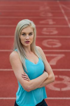 A beautiful young college athlete prepares herself for a track meet at a local university