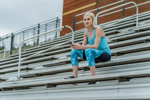 A beautiful young college athlete prepares herself for a track meet at a local university