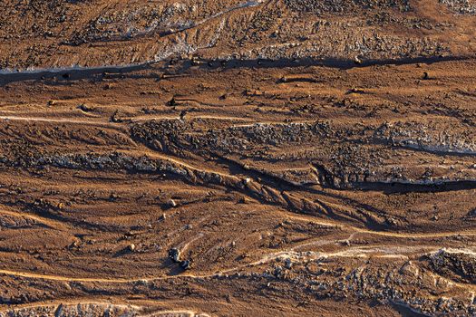 abstract mud background with water washout trails and selective focus.