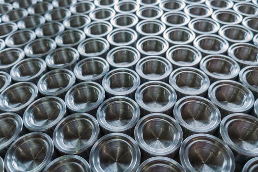 Shiny metal parts after cnc turning, on flat surface selective focus composition background.