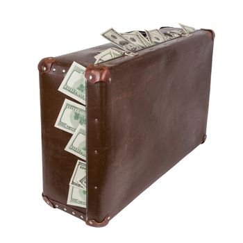 An old closed brown fiber suitcase with sticking out dollar banknotes. Standing up and isolated on white background.