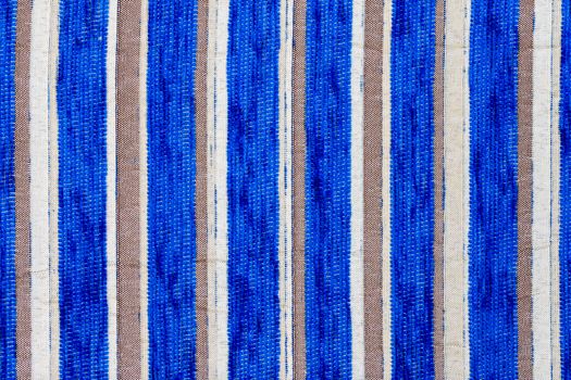 blue vertical striped synthetic woven upholstery fabric close-up texture and background