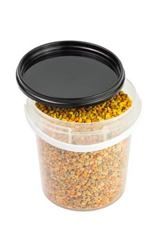 bee pollen granules in small opened plastic container isolated on white background