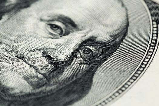 Boring close view of engraving portrait of Ben Franklin of old one hundred us dollars banknote. Selective focus with natural lens blur.