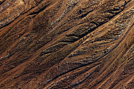 abstract mud background with water washout trails and selective focus.
