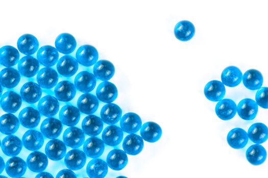 cyanspherical ball capsules with selective focus isolated on white background.