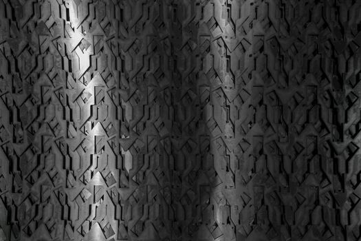Light glow on grill pattern. Dark grainy industrial abstract background.