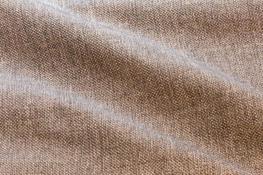 Brown waves dense rough fabric background, close up without any blurring