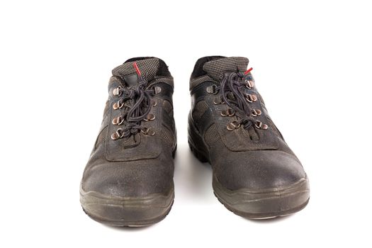 a pair of used blue leather work shoes with fabric incuts isolated on white background.