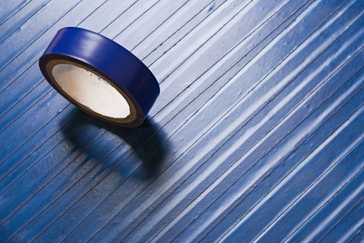 one roll of old blue pvc duct tape on surface covered by same tape