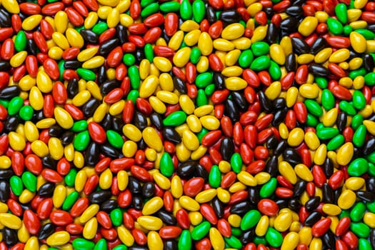 hundreds of small gloss glazed sunflower seeds multicolor flat background with selective focus illustrating gaussian distribution law