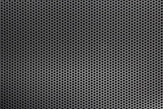 Black mesh screen background and texture with round hexagonal holes with selective focus