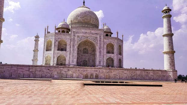 Front view Taj Mahal Tomb mausoleum with large pavilion in the foreground. It is a white marble of Mughal emperor Shah Jahan in memory of his wife Mumtaj. Taj Mahal is jewel of Muslim art and masterpieces of world heritage. Agra, Uttar Pradesh India South Asia Pac May 2019