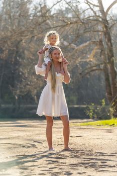 A beautiful young mother and her daughter enjoy the spring weather