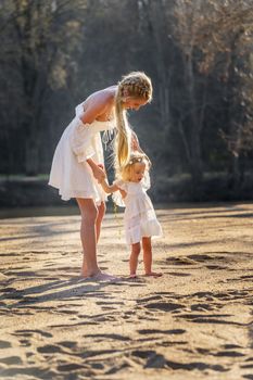 A beautiful young mother and her daughter enjoy the spring weather