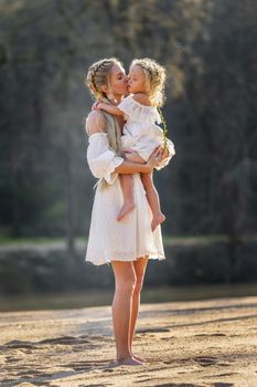 A beautiful young mother and her daughter enjoy the spring weather