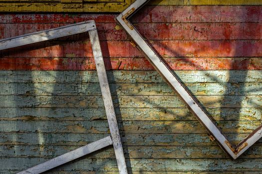Abstract composition with a frames on old wooden wall with weathered peeling paint