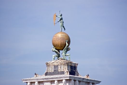The bronze and golden weathervane on top of the Dogana di Mare in Venice. Built where the Grand Canal meets the Giudecca Canal the Customs House is now an art gallery.