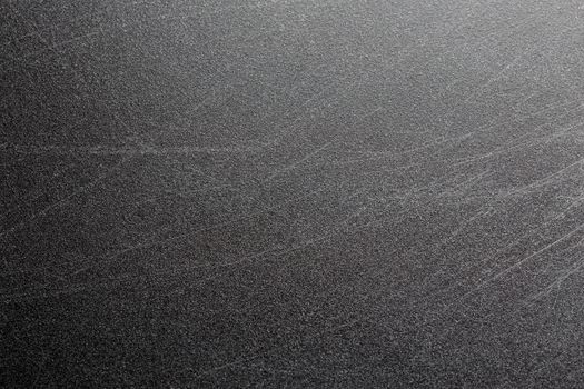 Abstract black scratched suface closeup background with selective focus