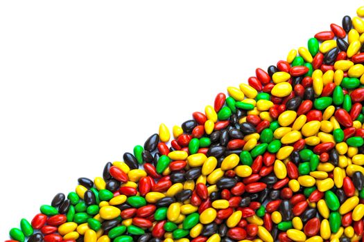 hundreds of small gloss glazed sunflower seeds multicolor flat background with selective focus with isolated side on white backgroud