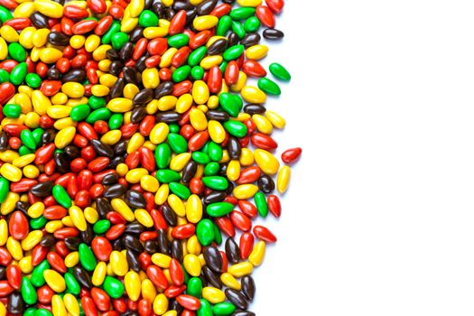 hundreds of small gloss glazed sunflower seeds multicolor flat background with selective focus with isolated side on white backgroud