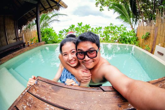 Asian couple love in swiming pool 