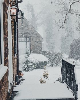 A Snow Covered Entryway To a Large Suburban Home During a Snow Storm