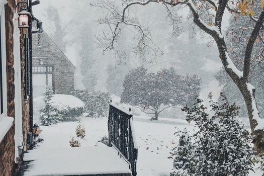 A Snow Covered Entryway To a Large Suburban Home During a Snow Storm