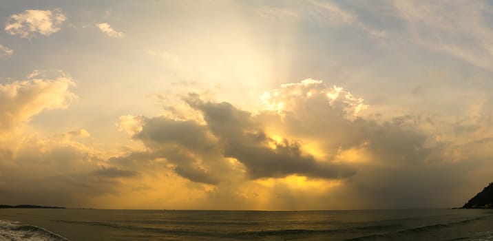 Panoramic sunset with fluffy clouds in the twilight sky,Sunlight with dramatic cloud over sea