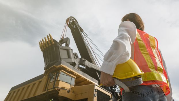 Worker in lignite or coal mining with the truck transporting coal.