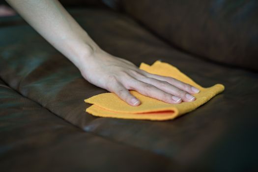 Women Hand cleaning sofa disinfectant for corona virus or Covid-19 protection.