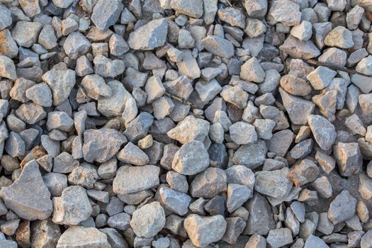flat macadam closeup background with pair of small dry sticks