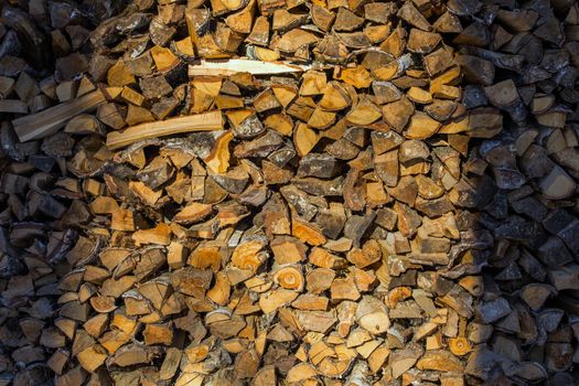 stack of firewood birch chunks with shadows on right and left sides