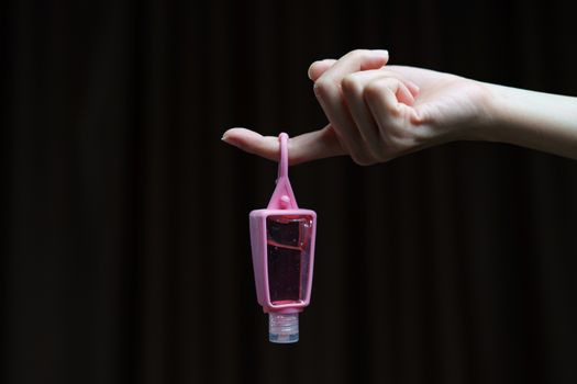 Hand holder pink silicone Sanitizer gel bottle for corona virus or Covid-19 protection.