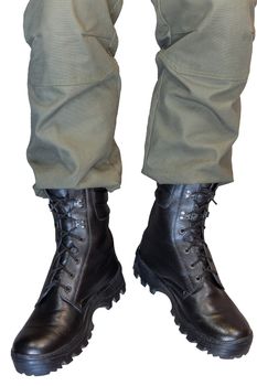 Legs in army khaki pants and military black boots isolated on white background